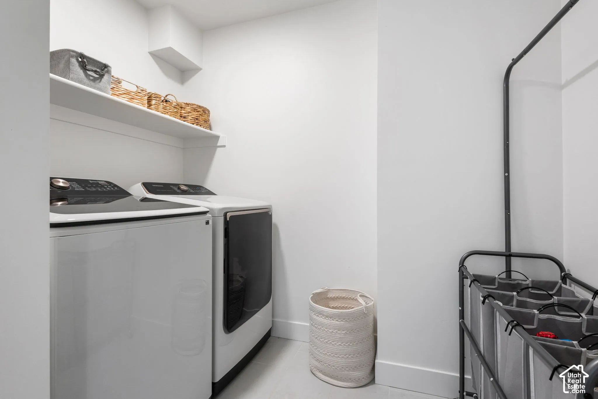 Utility area featuring an integrated white wall-mounted shelf and neutral wall finishes