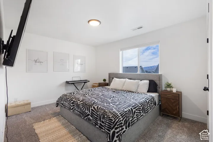 Neutral wall palette with carpeted flooring, flush-mount lighting, and window featuring mountain scenery