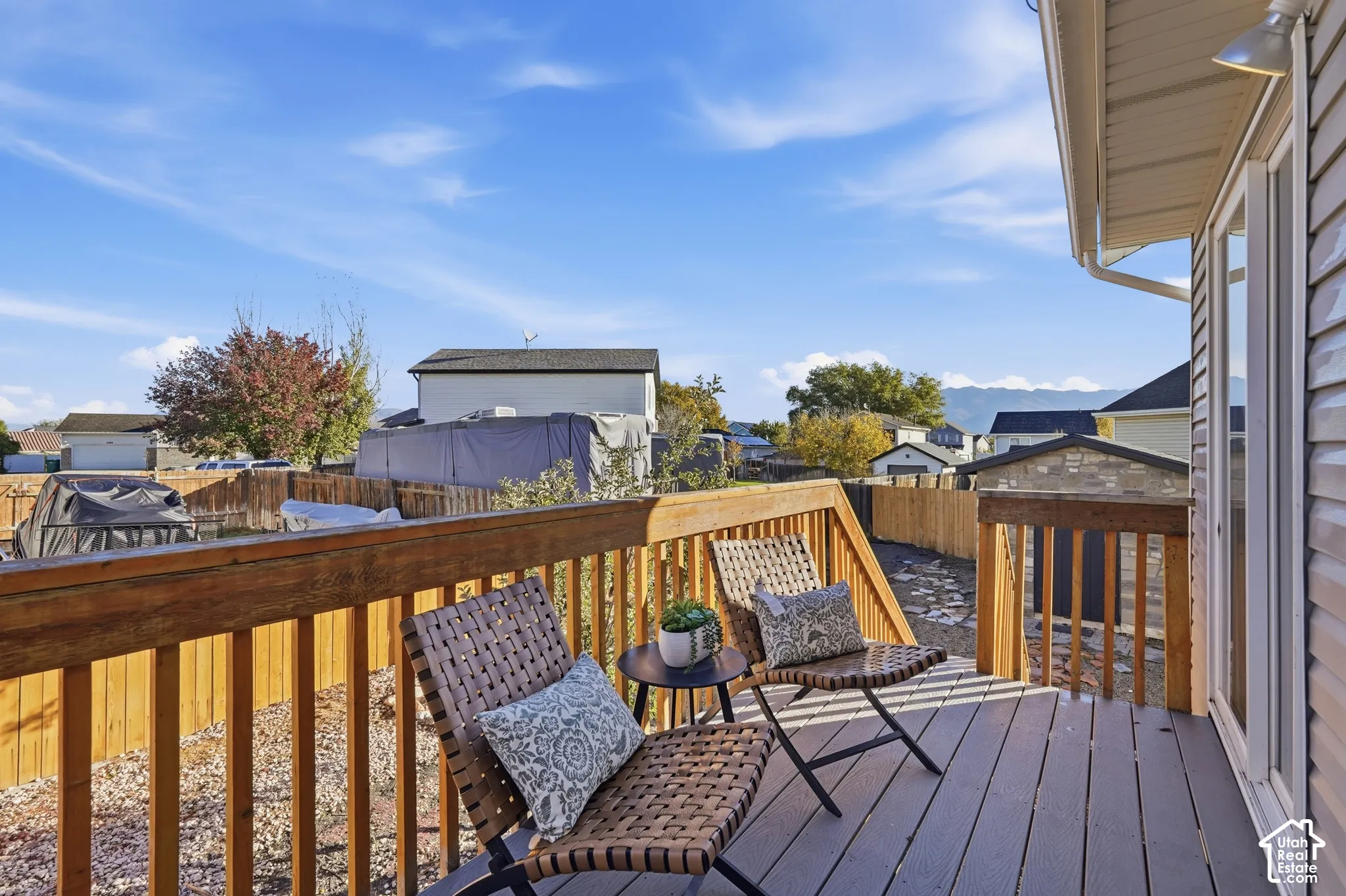 Elevated deck featuring composite decking, wood railing, and an exterior light fixture