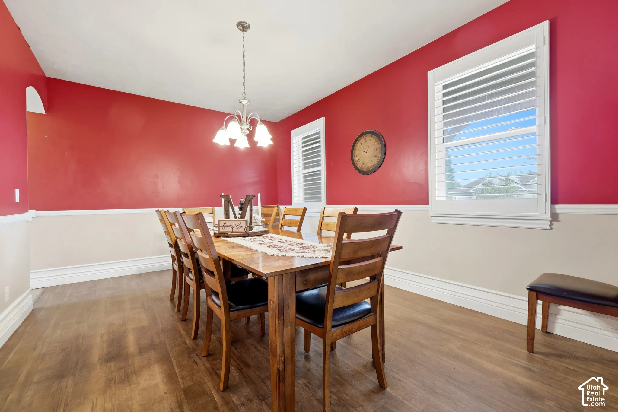 Wood-finish flooring, two-tone wall paint with chair rail molding, and plantation shutters