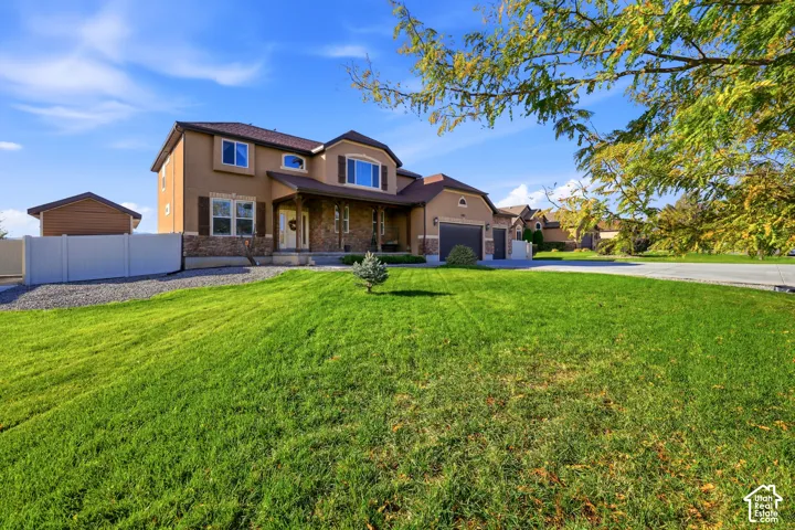 Two-story exterior featuring a stone and stucco fa
