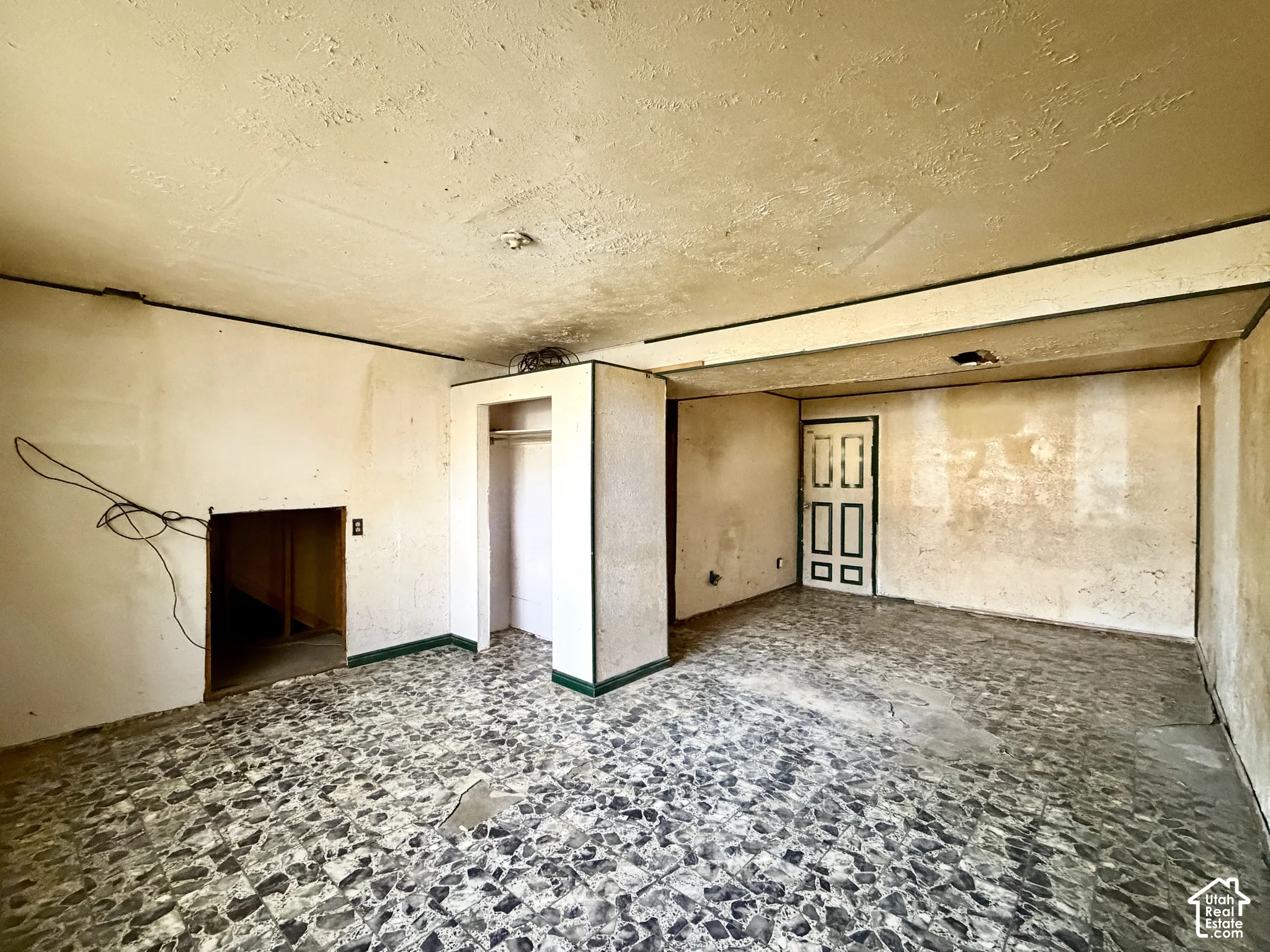 Interior space featuring patterned tile flooring, a built-in closet, and a multi-panel door