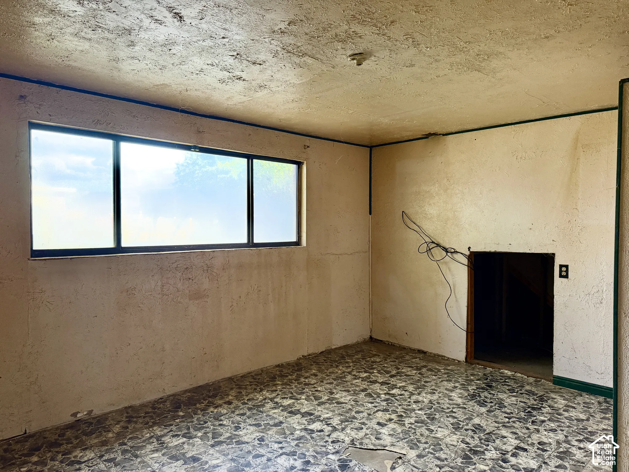Interior space featuring a large horizontal window and terrazzo flooring
