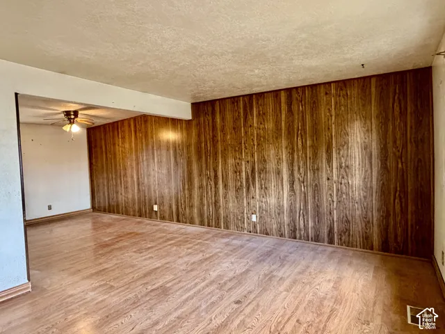 Wood-finish paneling, wood-finish flooring, and a ceiling-mounted light fixture