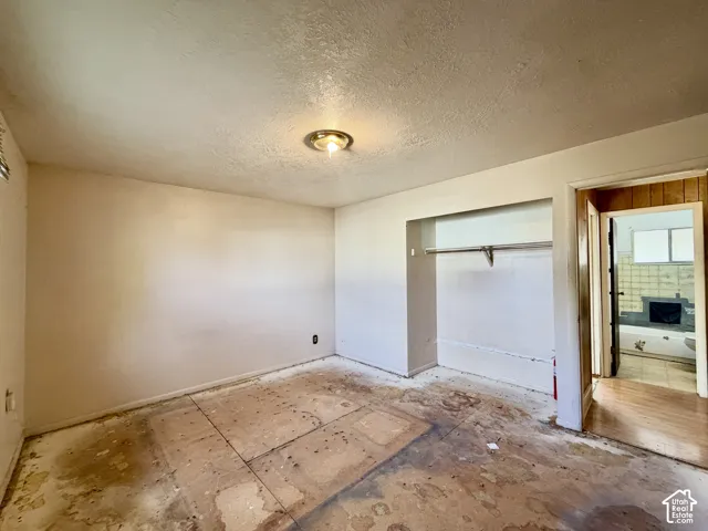 Interior room featuring a recessed storage alcove with a built-in metal garment rod and a central ceiling-mounted light fixture