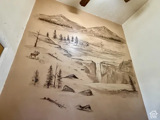 Wall surface featuring a custom, monochromatic mountain-themed mural