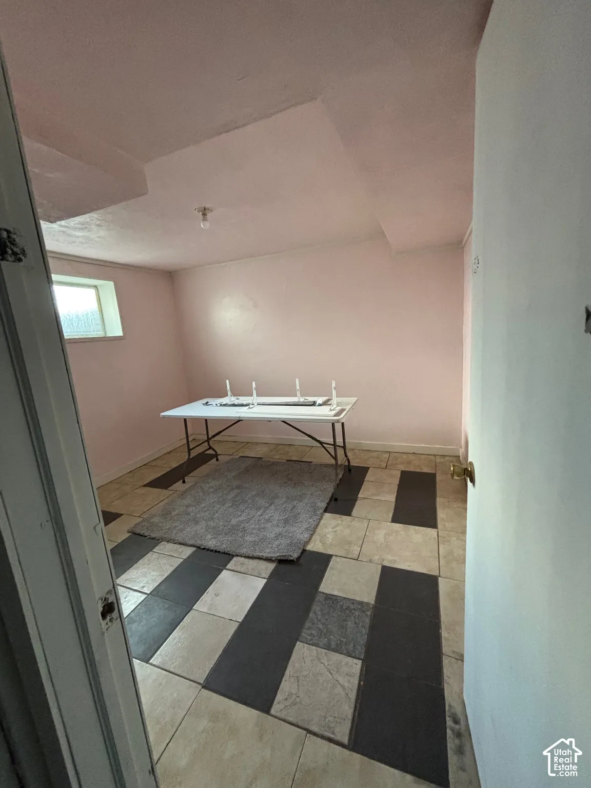 Interior space featuring geometric patterned tile flooring and a horizontal rectangular window