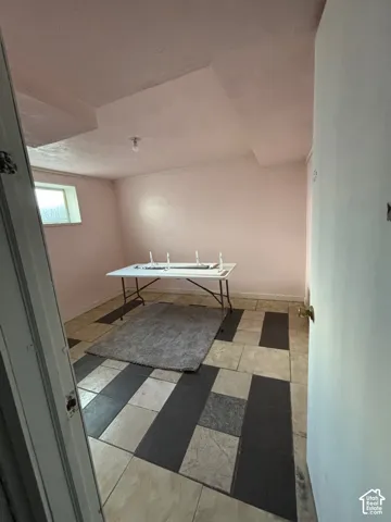 Interior space featuring geometric patterned tile flooring and a horizontal rectangular window