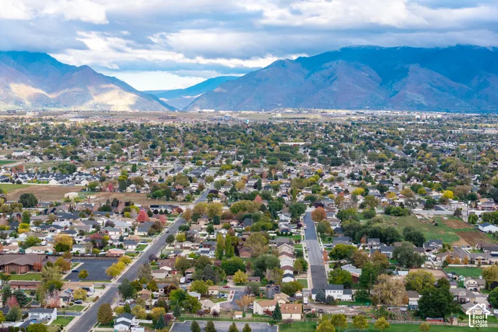 Aerial perspective featuring a panoramic mountain backdrop and expansive regional landscape
