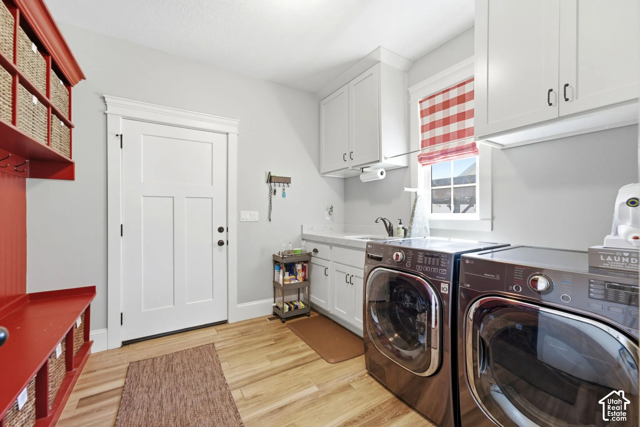 Laundry room featuring cabinetry, mud-room cubbies and sink. Walks out to garage