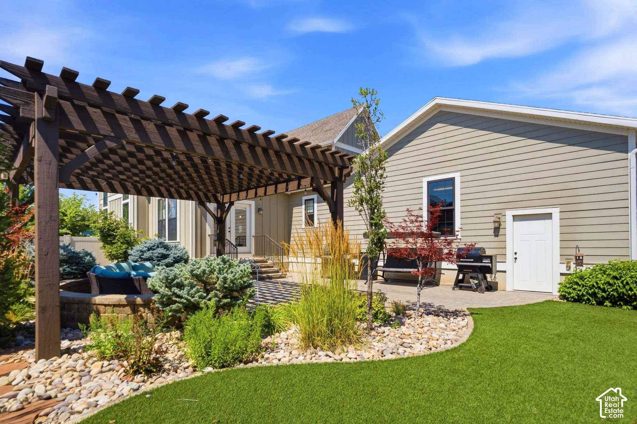 Back yard-view of patio, artificial turf and entrance to the garage