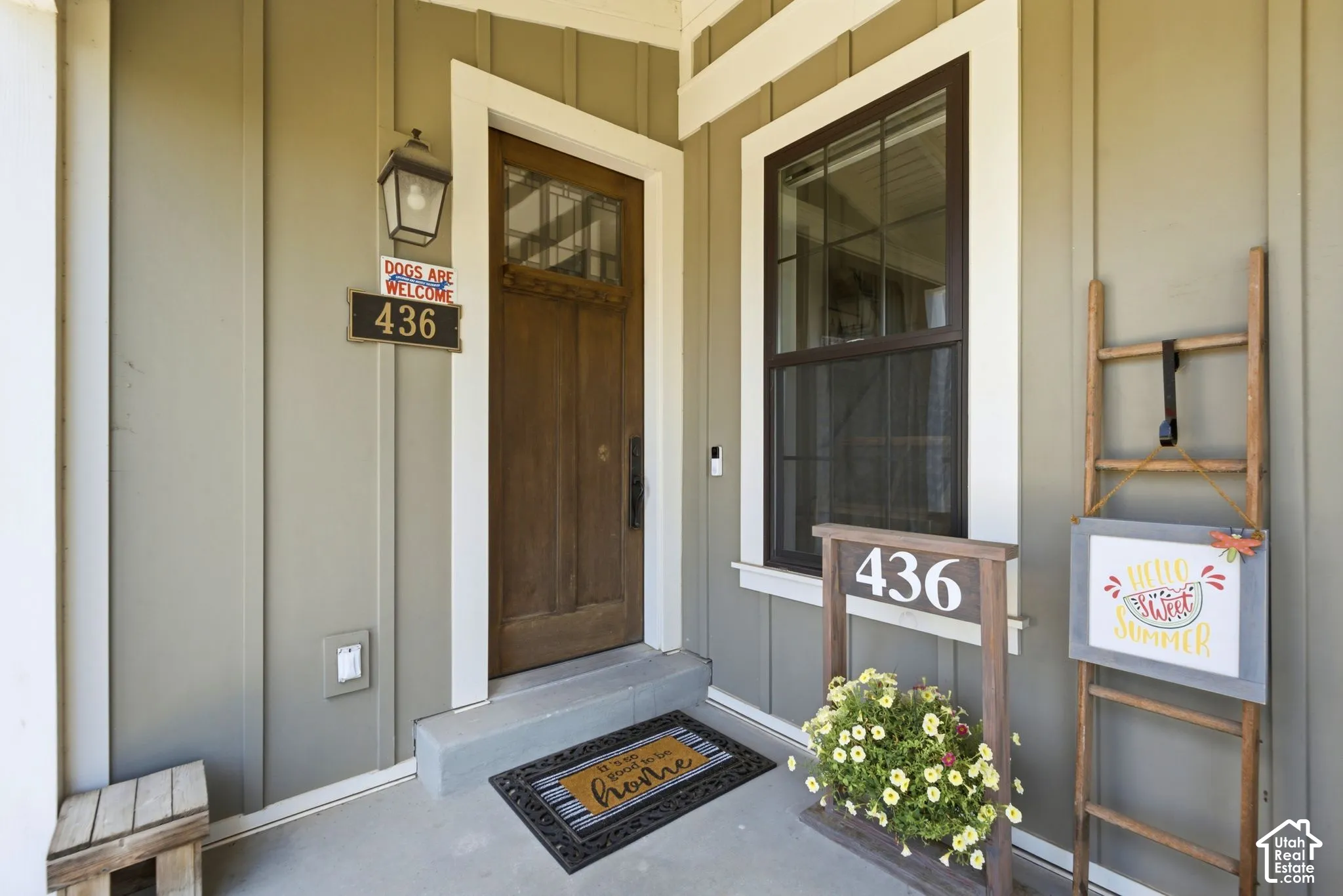 Covered entryway featuring vertical siding and solid wood entry door