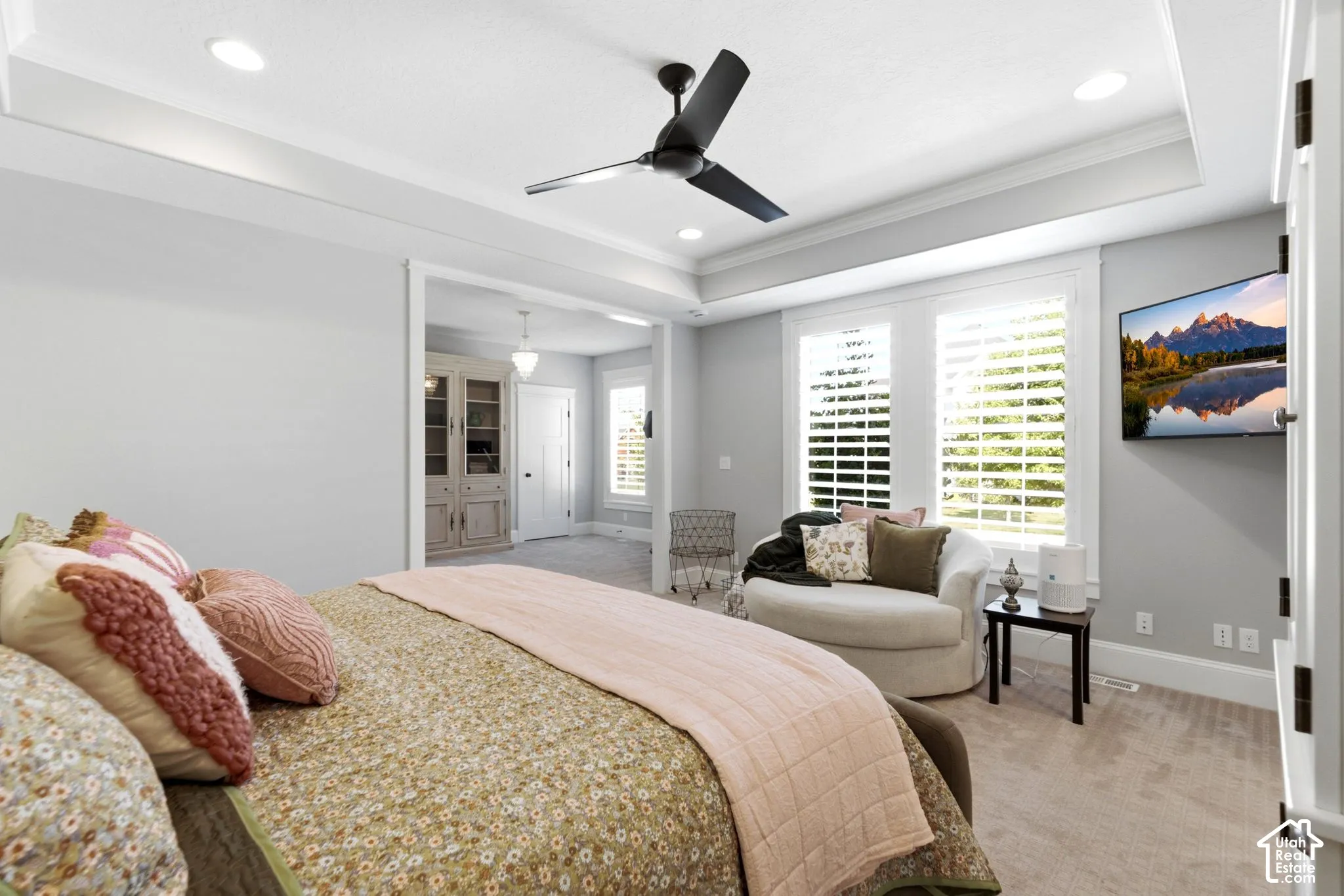 Main level spacious primary retreat offers plantation shutters
