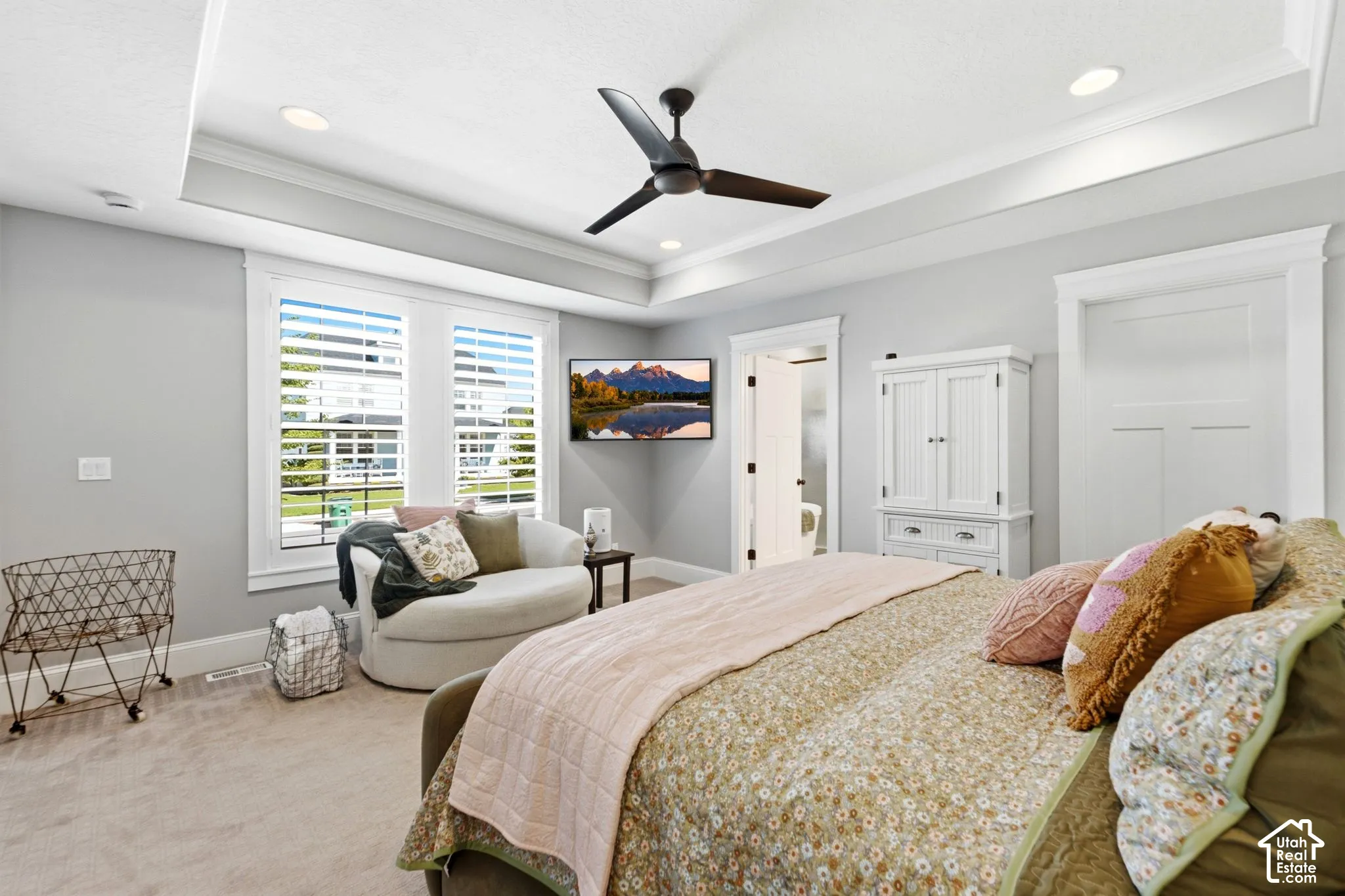 Main level spacious primary retreat with tray ceiling with recessed lighting