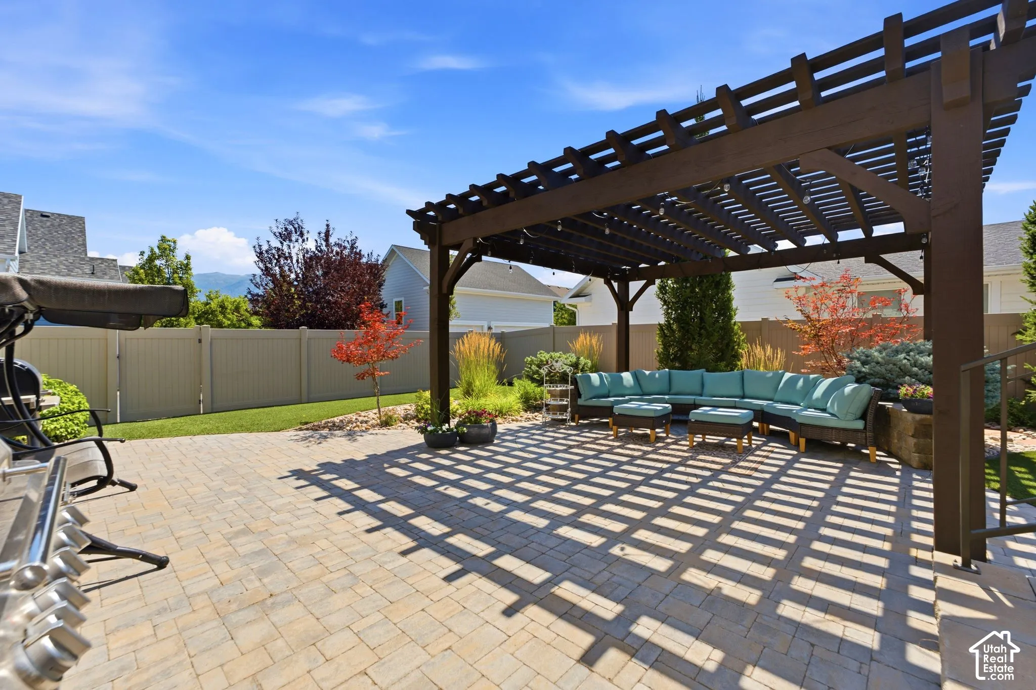 Fenced back yard offers large custom pergola for entertaining or relaxing
