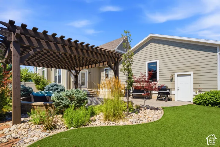 Back yard-view of patio, artificial turf and entrance to the garage