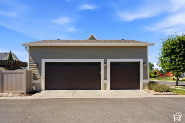 3-car garage featuring horizontal siding, dark finish sectional doors