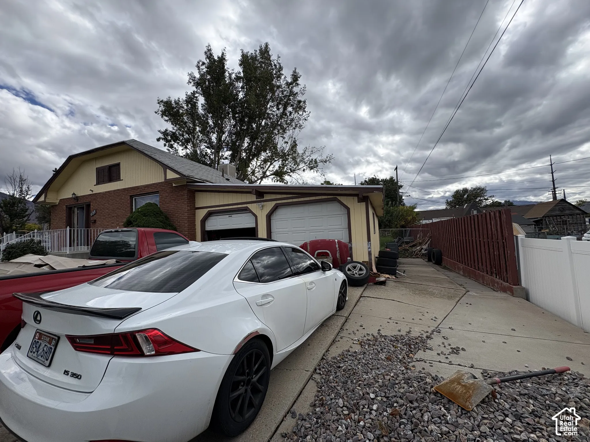 Exterior featuring a brick and painted siding facade with a two-car attached garage and concrete driveway