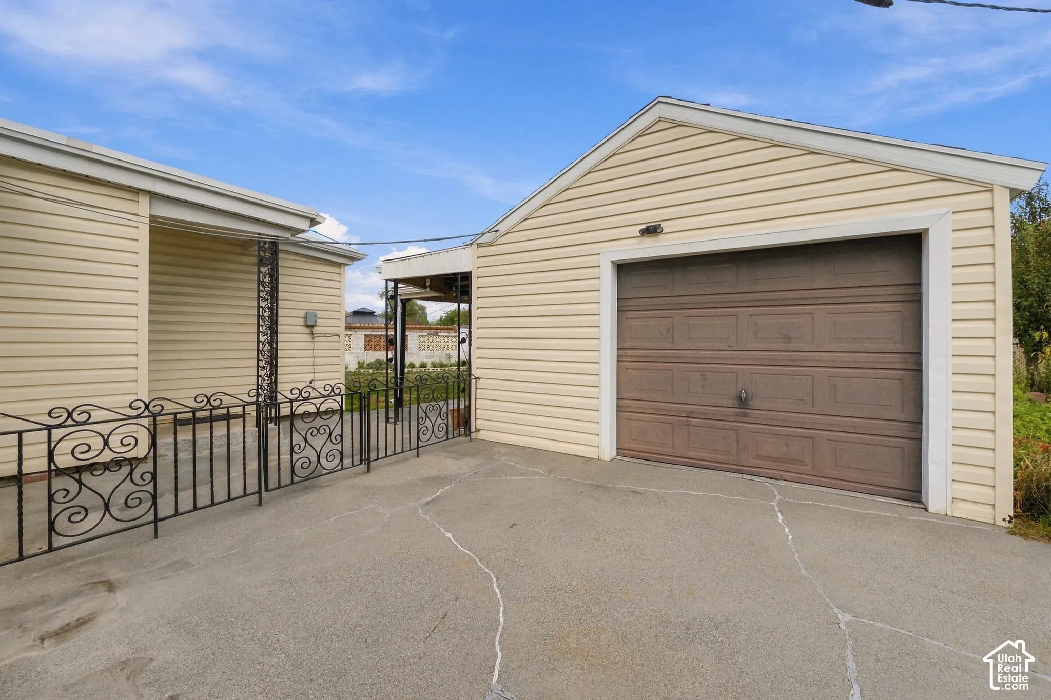 Detached garage with siding, concrete driveway