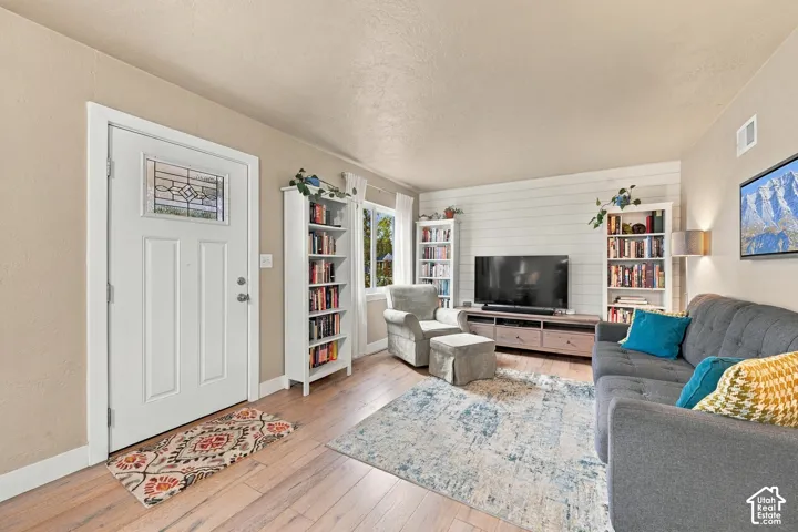 Front Entrance featuring wood-finish flooring and shiplap wall