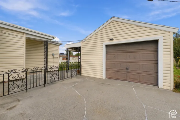 Detached garage with siding, concrete driveway
