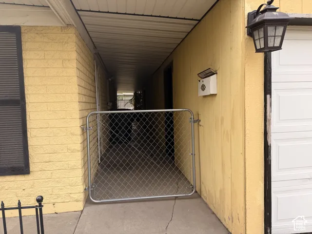 Breezeway between garage and kitchen doors. Separate workshop room behind garage