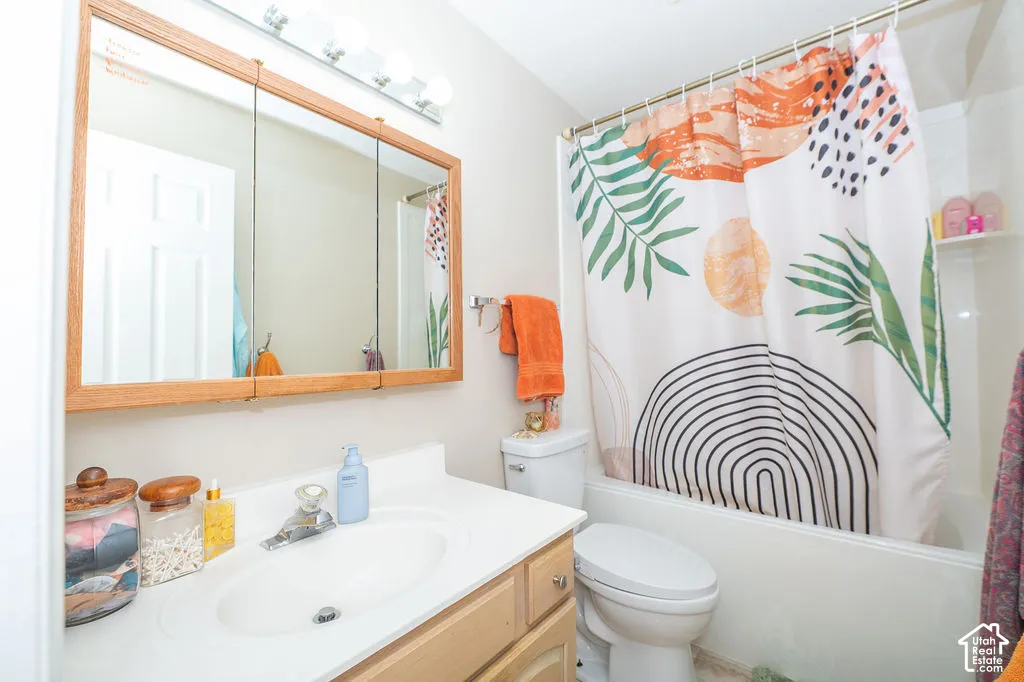 Bathroom featuring a wood-frame tri-view medicine cabinet, a single-basin vanity with an integrated countertop, and a shower-tub combination with a white surround