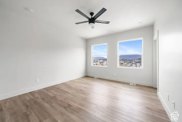 Interior space featuring wood-finish flooring, neutral wall paint, recessed lighting, and a modern ceiling fan