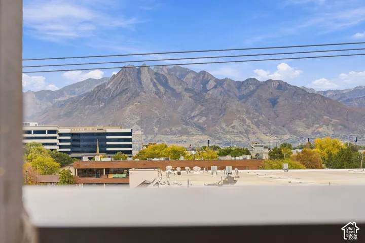 Prominent mountain range backdrop with blue sky exposure