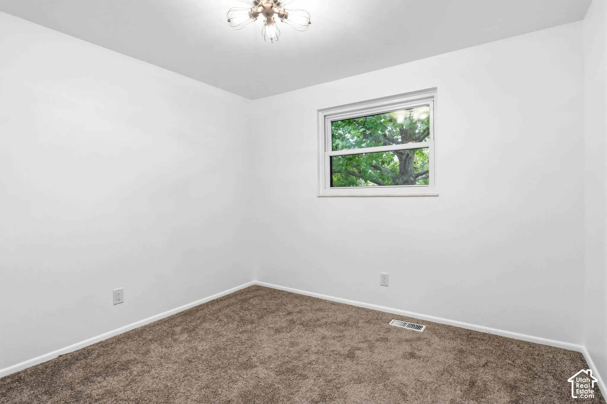 Bedroom 2 level 2-Neutral-toned carpeted flooring, multi-light ceiling fixture, and a single-hung window with exterior tree foliage