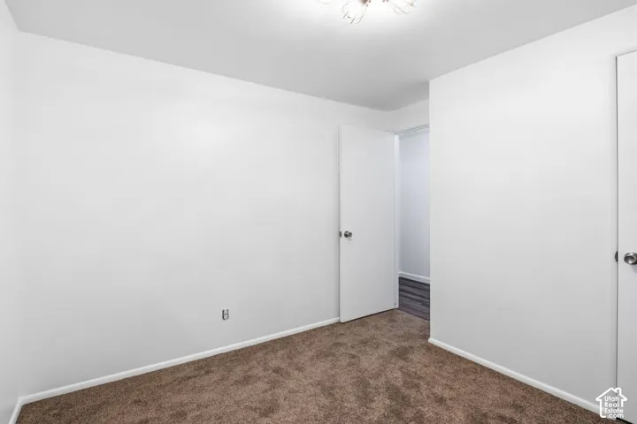 Bedroom 2-Interior space featuring neutral wall tones, wall-to-wall carpeting, and a multi-arm flush-mount light fixture