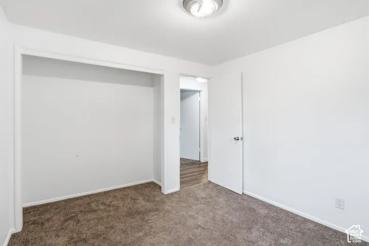 Bedroom 3-Neutral-toned carpeting, flush-mount ceiling lighting, and a recessed closet space with a flat-panel interior door