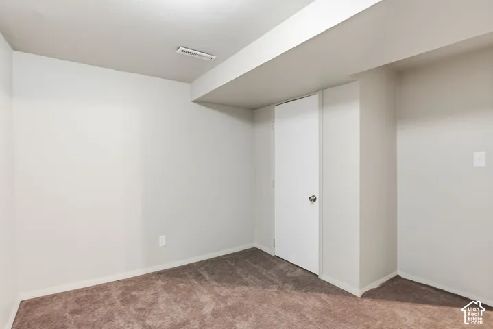 Neutral wall palette, wall-to-wall carpeting, and a single-panel interior door