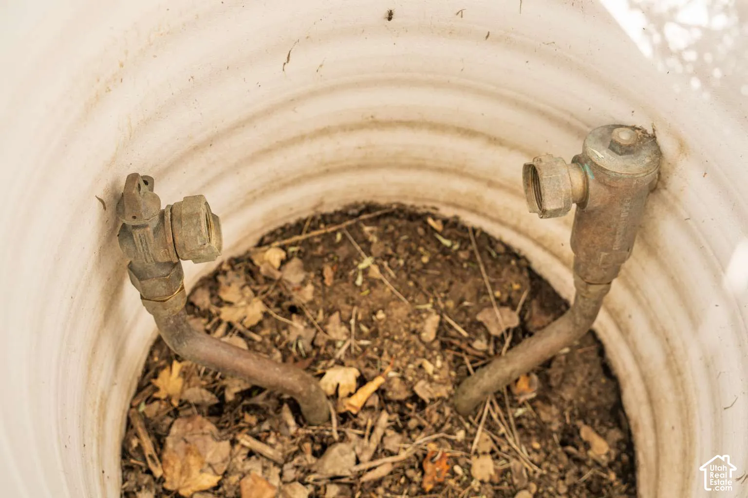 In-ground irrigation valve box containing two brass plumbing fixtures