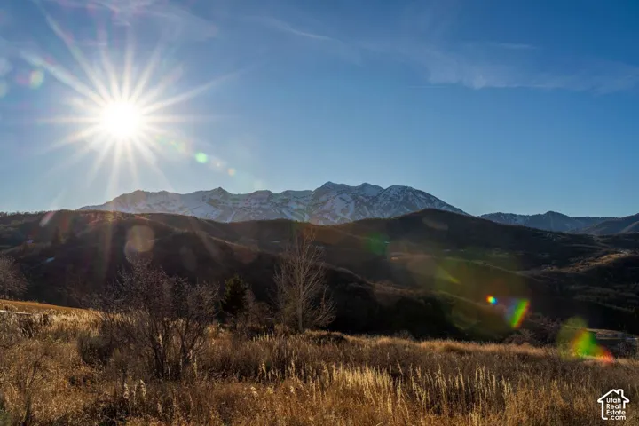 Expansive mountain landscape featuring rugged terrain and snow-capped peaks