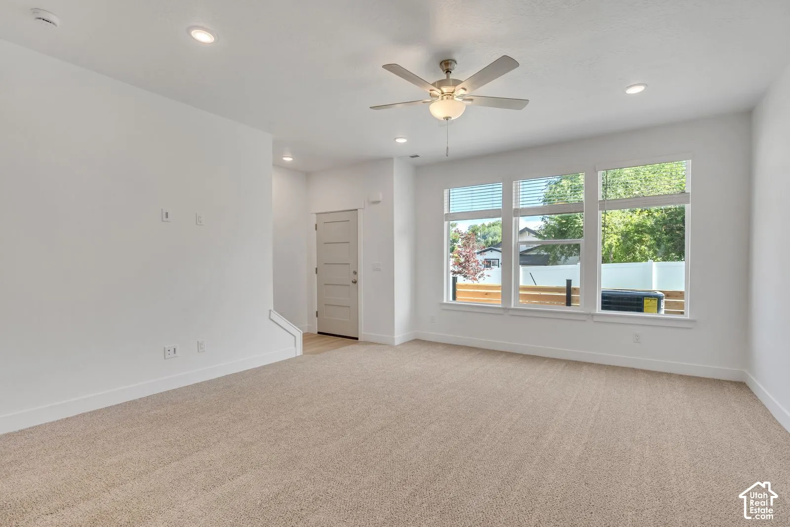 Interior space featuring recessed lighting, a ceiling fan with integrated light, triple-panel windows, and a multi-panel door