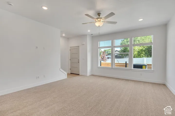 Interior space featuring recessed lighting, a ceiling fan with integrated light, triple-panel windows, and a multi-panel door