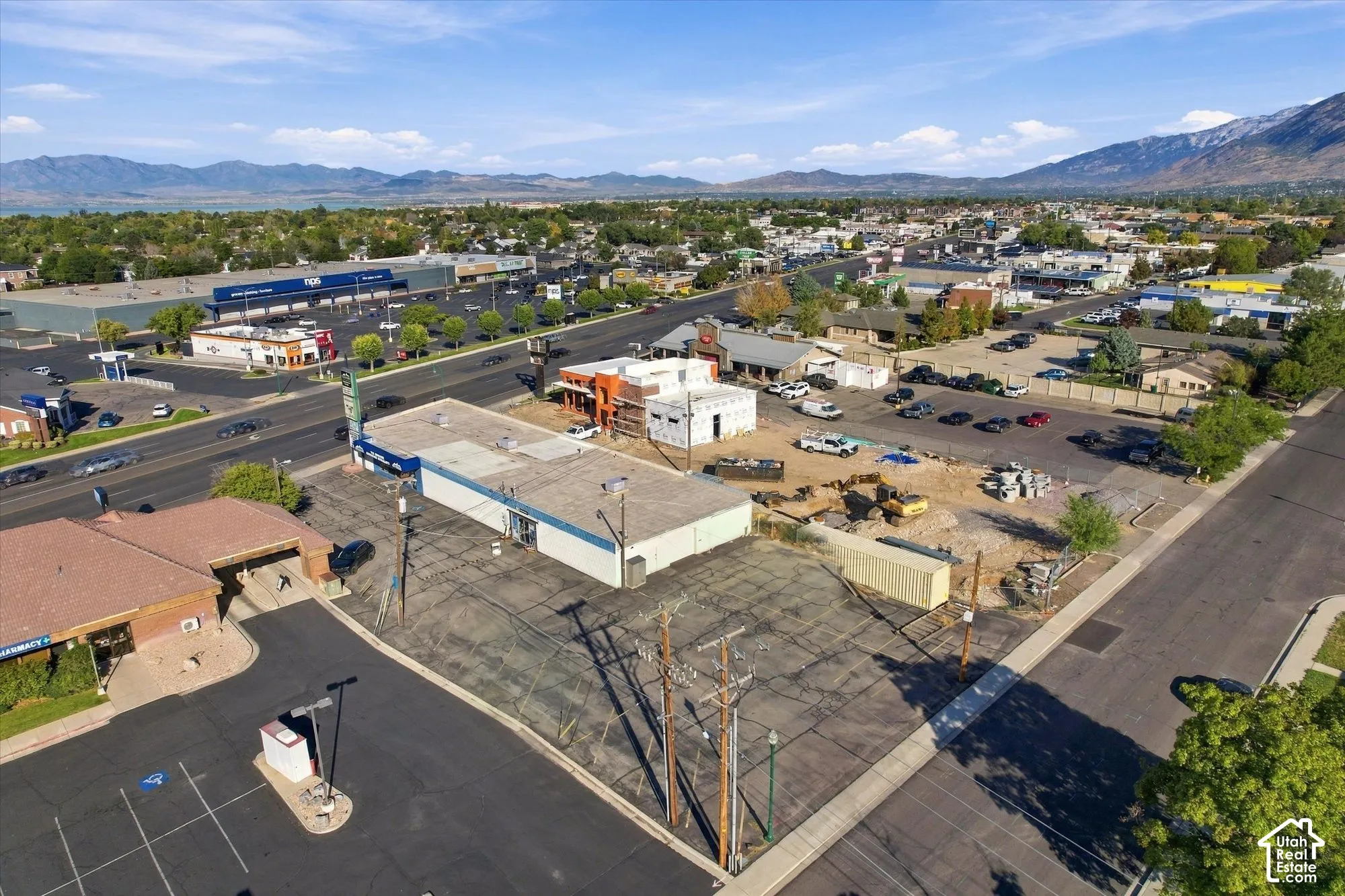 Commercial property featuring paved parking, direct street access, and mountain surroundings