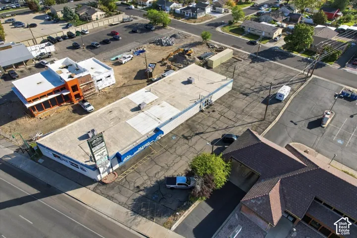 Commercial property featuring a flat roof structure, asphalt-paved surface, and an integrated freestanding signage display