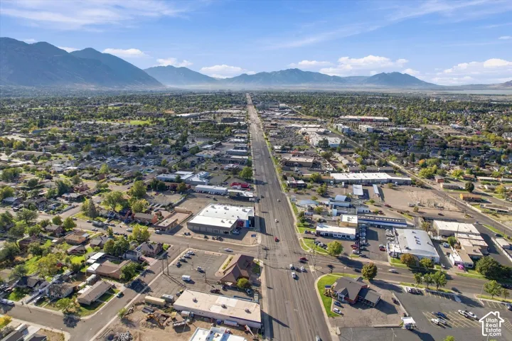 Aerial perspective featuring expansive mountain range backdrop and established grid-patterned neighborhood infrastructure