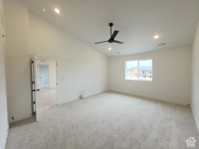 Vaulted ceiling featuring a matte black ceiling fan, recessed lighting, and wall-to-wall carpeting