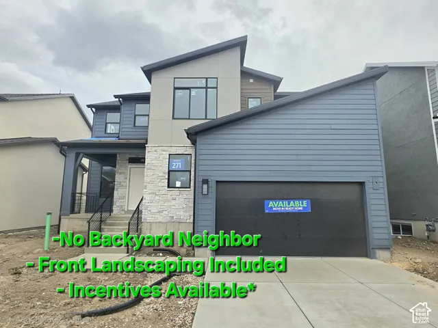 Multi-level exterior featuring a combination of horizontal lap siding and stacked stone veneer, a covered entryway with metal railing, and an attached two-car garage