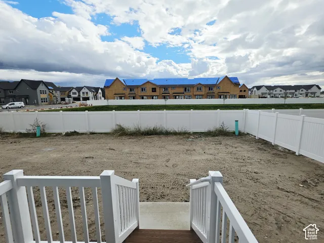 Backyard space featuring a white vinyl privacy fence and a composite deck with white railings