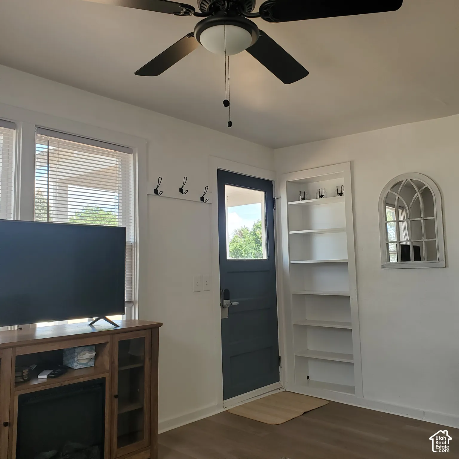 Inviting entry way with Built-in recessed shelving and coat hooks.