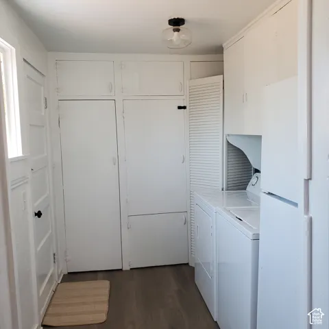 Utility area featuring floor-to-ceiling built-in cabinetry, wood-finish LVP flooring - Fridge, Washer and Dryer are included!