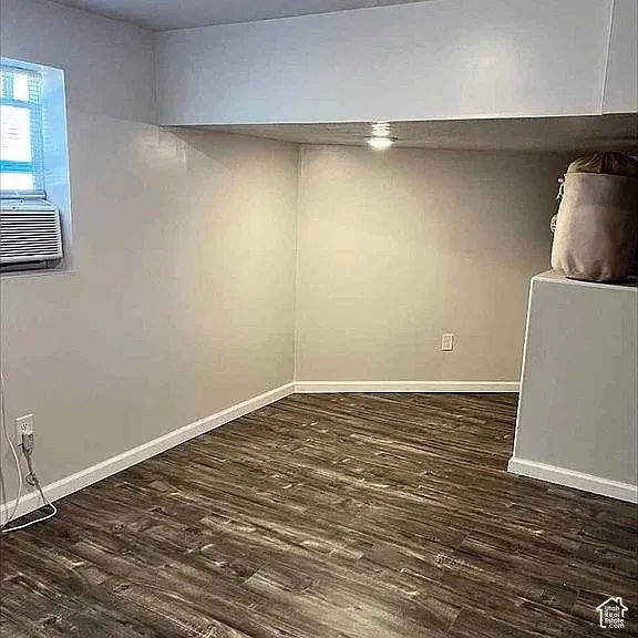 Interior space featuring wood-finish flooring, recessed ceiling lighting, and a window with a recessed frame