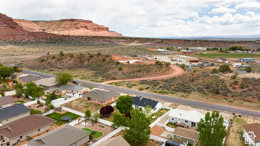 Aerial perspective showcasing established residential neighborhood topography with prominent red rock geological formations in the distance