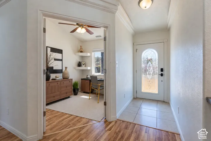 Entryway featuring tile flooring and a front door with an arched glass insert