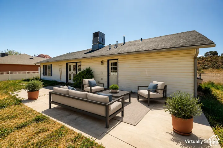 Exterior featuring horizontal siding, a concrete patio, and french doors