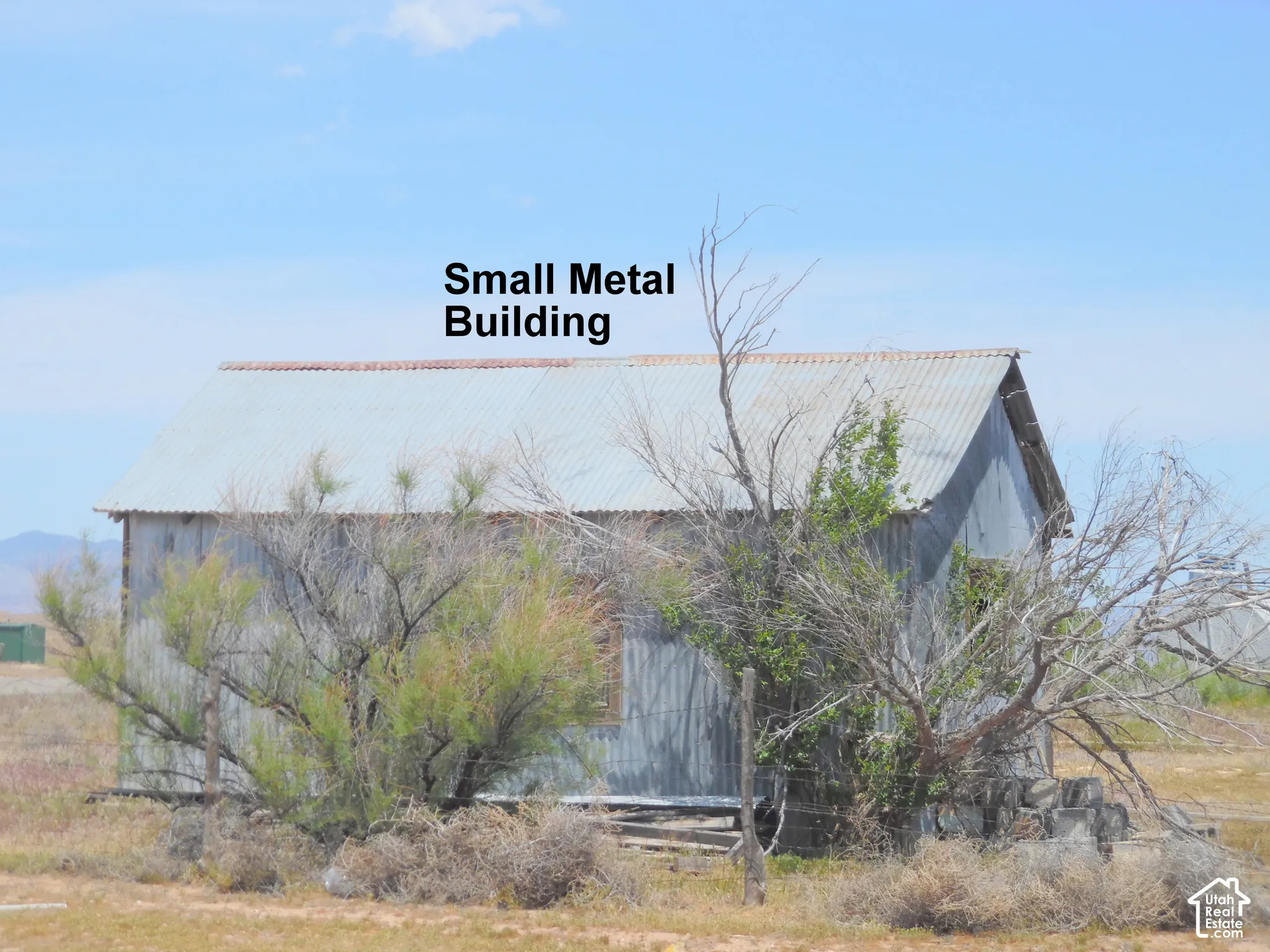 Detached metal structure featuring a gable roof and corrugated metal siding